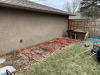 Thumbnail photo of an empty garden bed, with red lines showing where the raised beds will be.